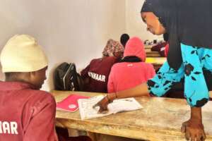 Teacher Aminata Sow supporting Abdoulaye