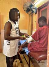 Alagie cares for a talibe child in the infirmary.