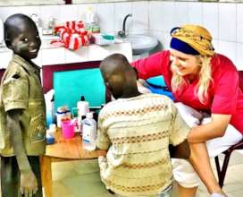 Lise treating a child's infected foot