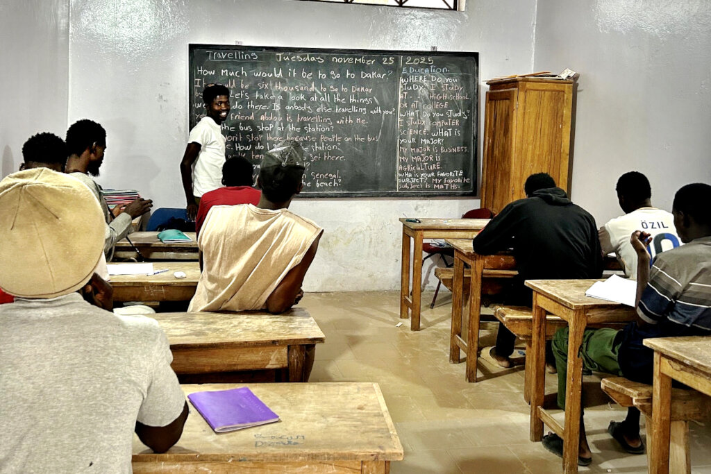 Kalidou enthusiastically teaching an English class