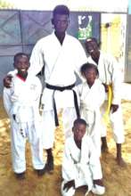 Buaro with four aspiring students in MDG center