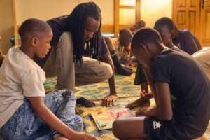 Educator Samba Ndong with the children