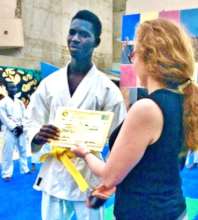 Issa receiving his yellow belt from Sonia LeRoy