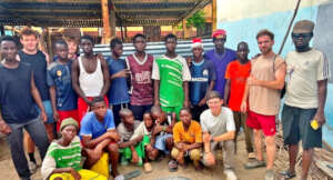 Volunteers and talibes renovating their daara