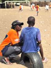 Lalla gently coaches one of her players.