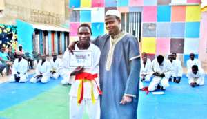 Mamadou receives his new orange belt