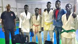 Issa (smiling) with Sor-Karate competition team