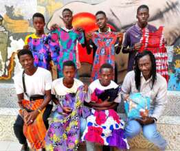 Issa with seven sewing-apprenticeship graduates