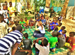 Mila leading games in the courtyard of MDG center