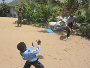 Malick playing with Bathe and a volunteer