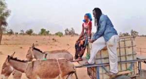 Issa and child fetch water 4 km from village