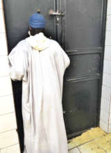 A marabout in front of the prison door