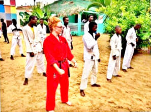 Sonia, now a brown belt, leading class in the heat