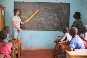 Sam teaching a French class, while Issa watches