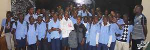 Arouna surrounded by his high school classmates