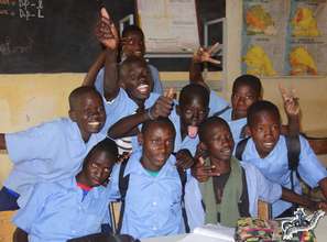 Arouna with his school friends in his classroom