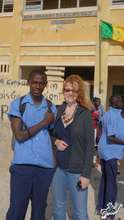 Arouna in front of his school with Sonia LeRoy