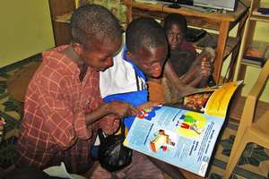 Street children discover a book for the first time