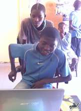 Ablae watchs Kalidou chat with his Canadian friend
