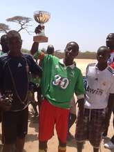 Lamine, team captain, proudly hoists the trophy