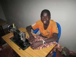 Kalidou learns tailoring at MDG center - Dec. 2011