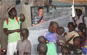 Issa organizing mosquito net installation in daara