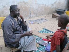 Marabout Seck instructing a child