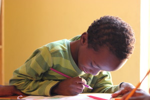 Child intent on coloring in MDG library