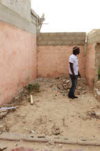 Issa shows me where the new building will be built