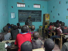 Teacher Aida Dieng with talibe students