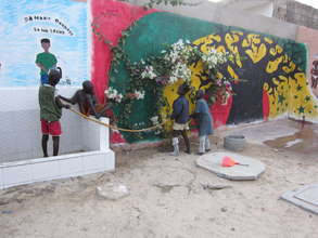 Talibes watering bougainvillea, by hygiene station