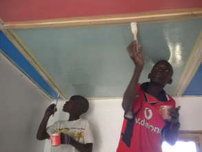 Talibes painting ceiling of new MDG infirmary