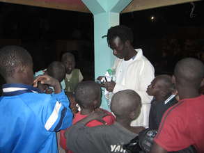 Issa distributing tooth brushes to eager talibes