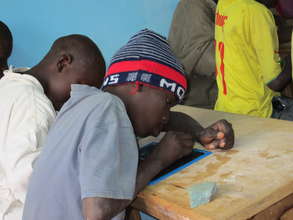 Talibe student concentrating in MDG classroom