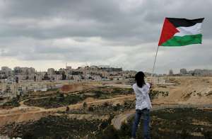 Freedom Rider waving a flag close to a settlement