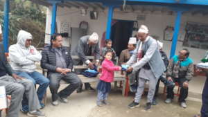 A committe member providing a school dress to  a c