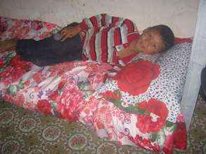 a boy Sundar is sleeping  in his bed