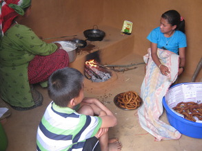 The kids and the care taker mother in the kitchen