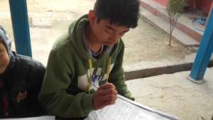 A   boy reading  hie book