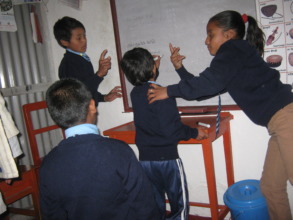 Kids using white board to  learn to   to write