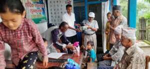 SESF Chairperson distributing clothes