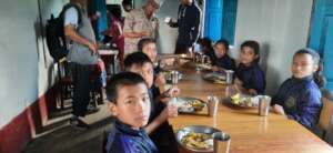 The school kids attending at a feast at canteen.
