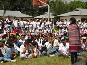 Students watch a theatre performance in Lospalos