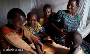 Genevieve and her family under their PSI bed net