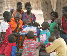 Village elders sharing information about bed nets