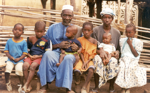 An elder of Djendji village with schoolchildren