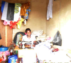 Tailoring graduate at her shop
