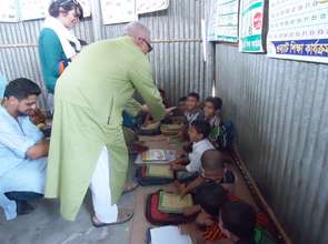 Anwar Khan, greeting Rangpur Preschool kids