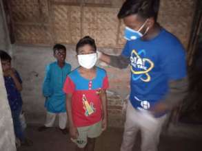 Think Tank volunteer affixes a mask - 1