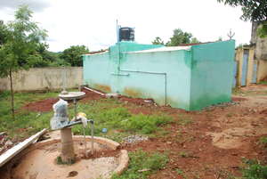School toilet, with overhead tank and motor